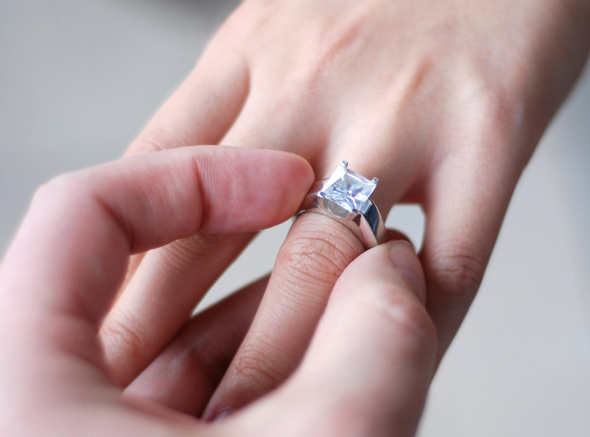 princess engagement ring on finger