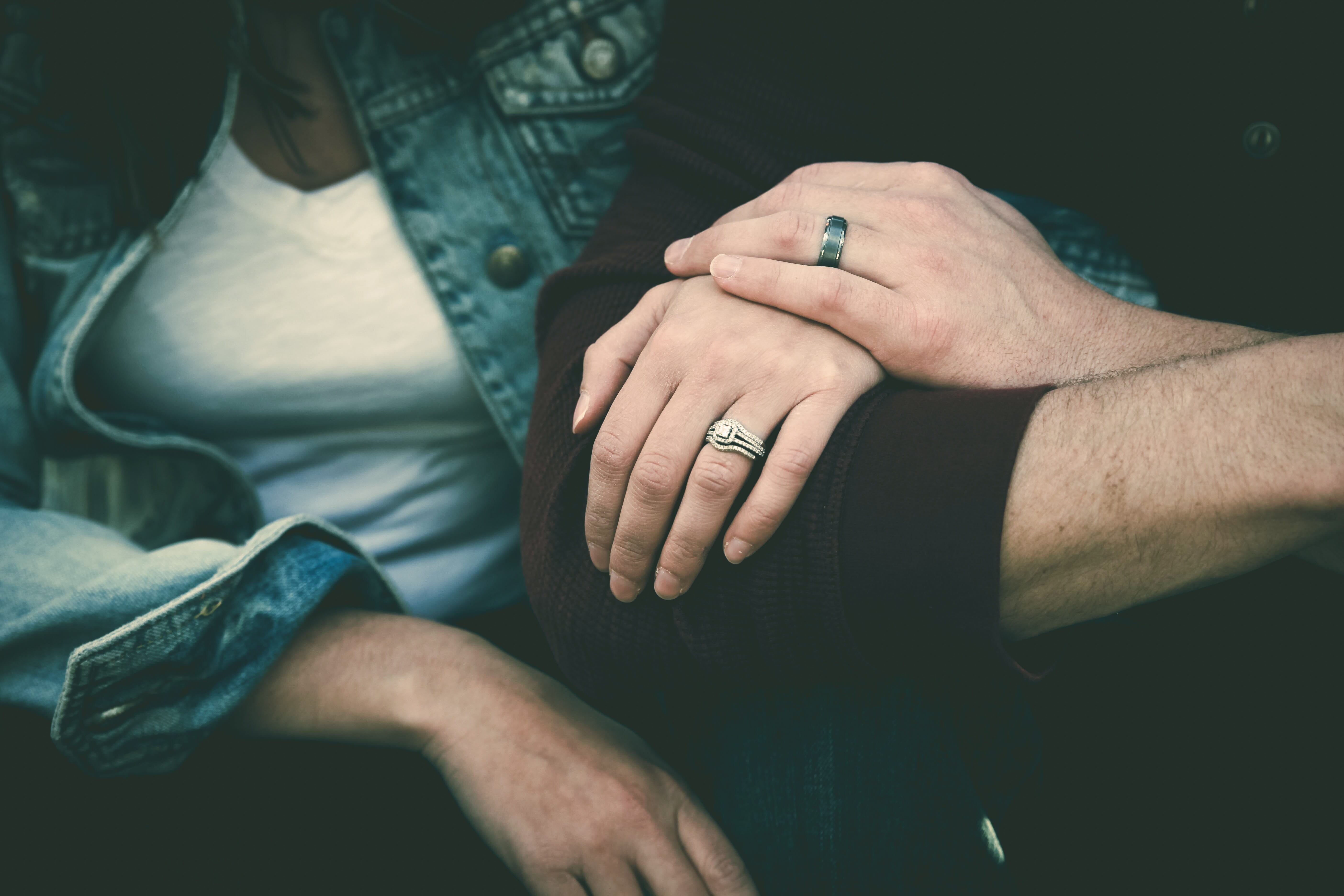 holding hands wedding rings