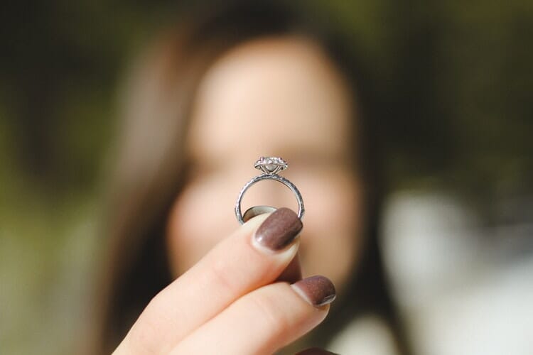 holding a diamond ring